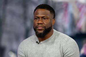Kevin Hart wearing a casual sweater, looking serious during an interview