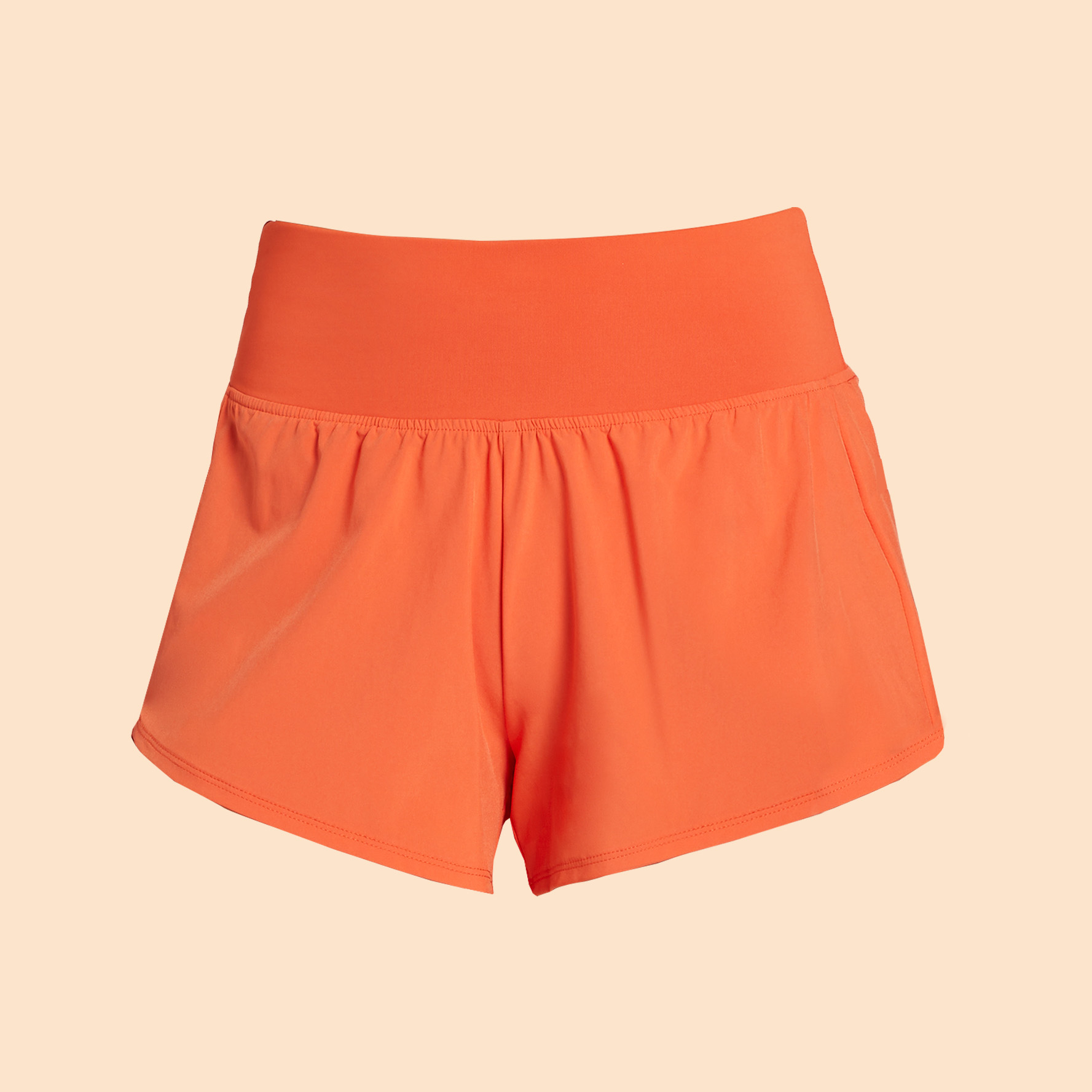 Orange athletic shorts on a neutral background