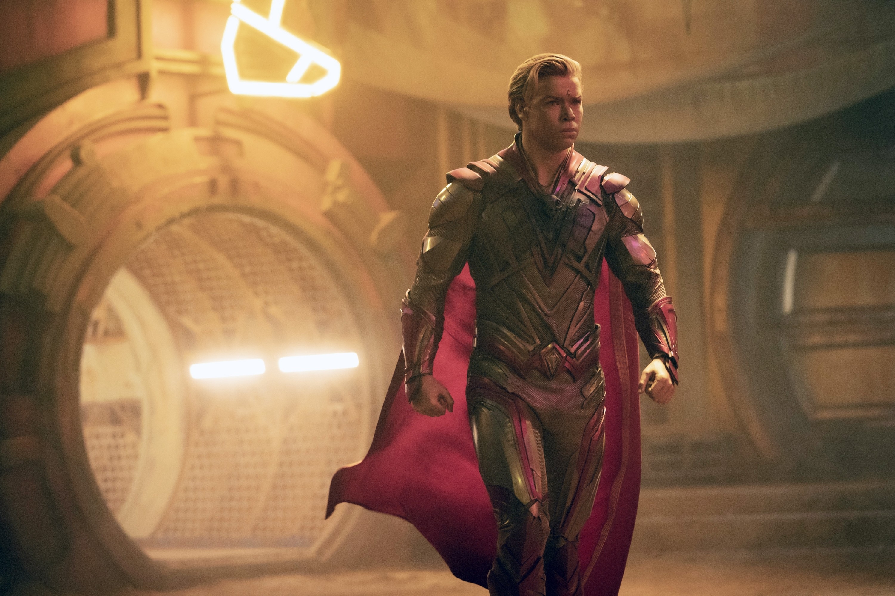 in a scene, Will as Adam Warlock in a superhero suit with a cape, standing confidently in a corridor