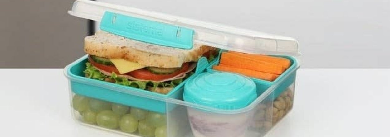 A lunchbox with compartments for a sandwich, veggies, fruits, and a small container for dips