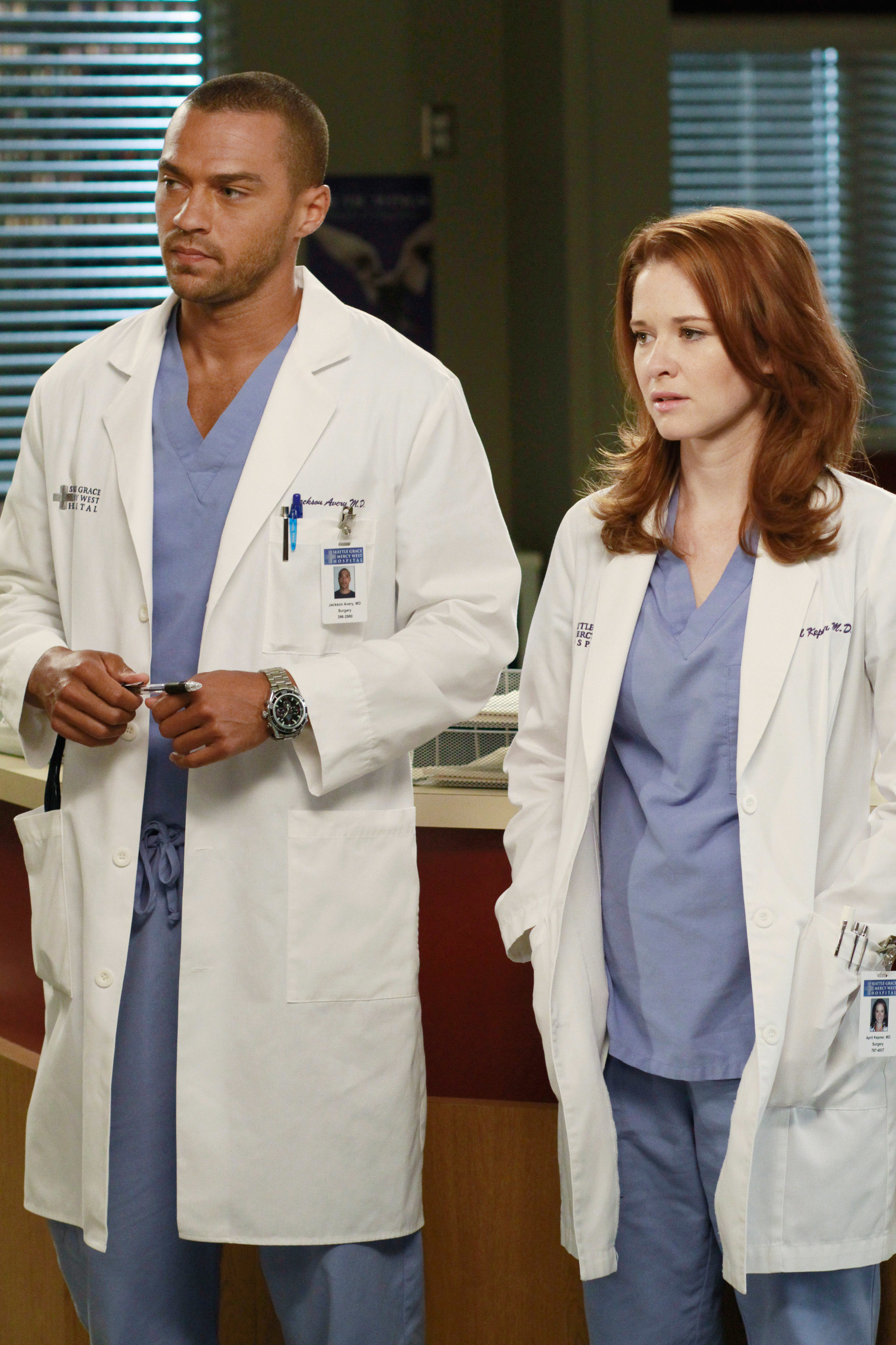 Two actors in medical attire on the set of a hospital-themed TV show