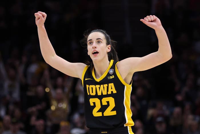 Basketball player in Iowa jersey #22 celebrates during a game