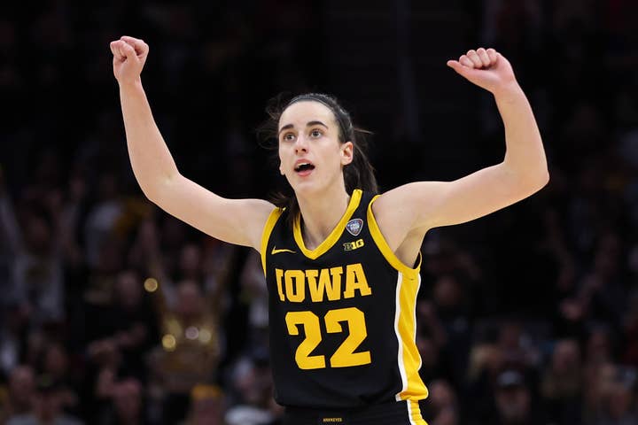 Basketball player in Iowa jersey #22 celebrates during a game