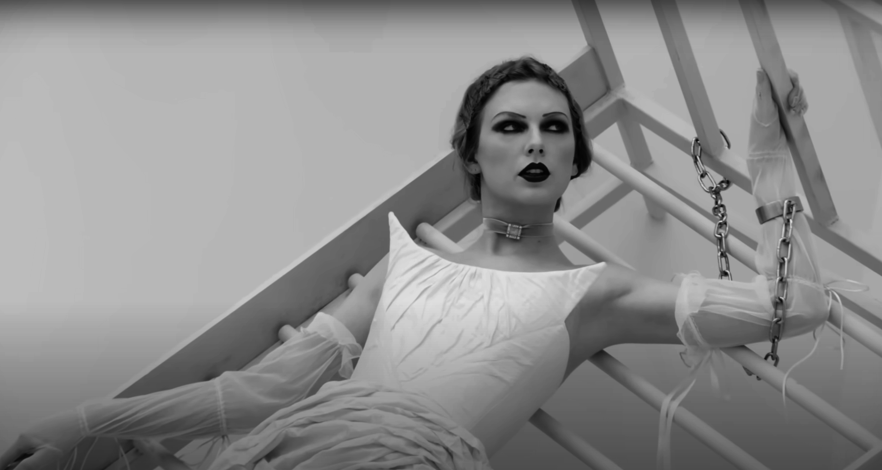 in music video scene, Taylor in a stylish gown, bound by chains, with a dramatic expression