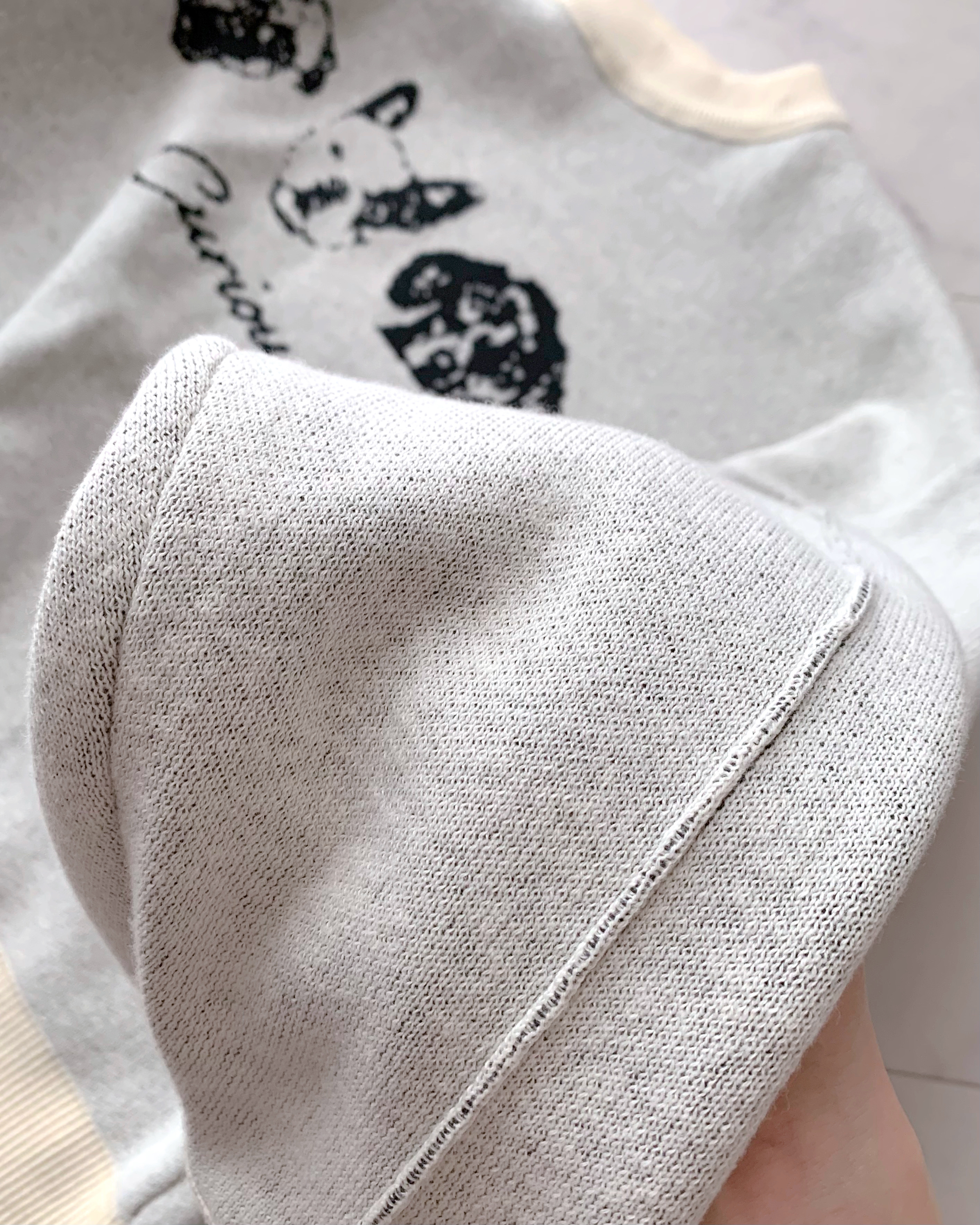 Close-up of a textured white fabric cap with a neatly stitched seam