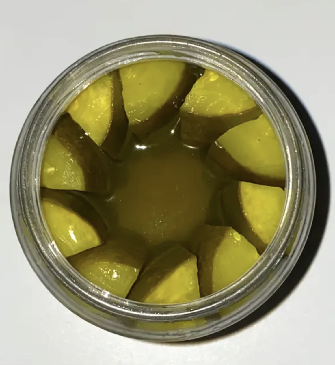 Top view of a jar filled with sliced pickles