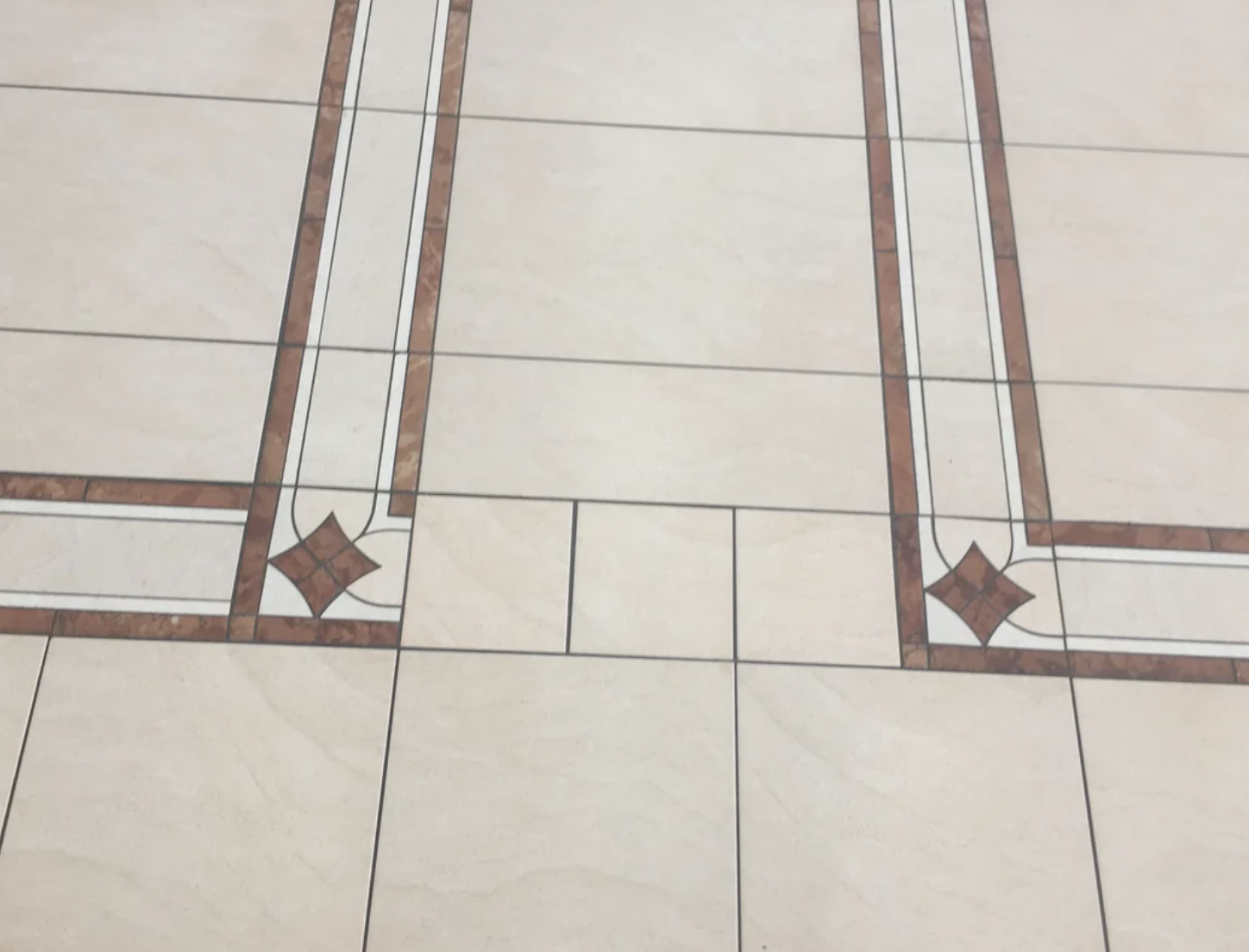 Tiled floor with geometric patterns and decorative borders
