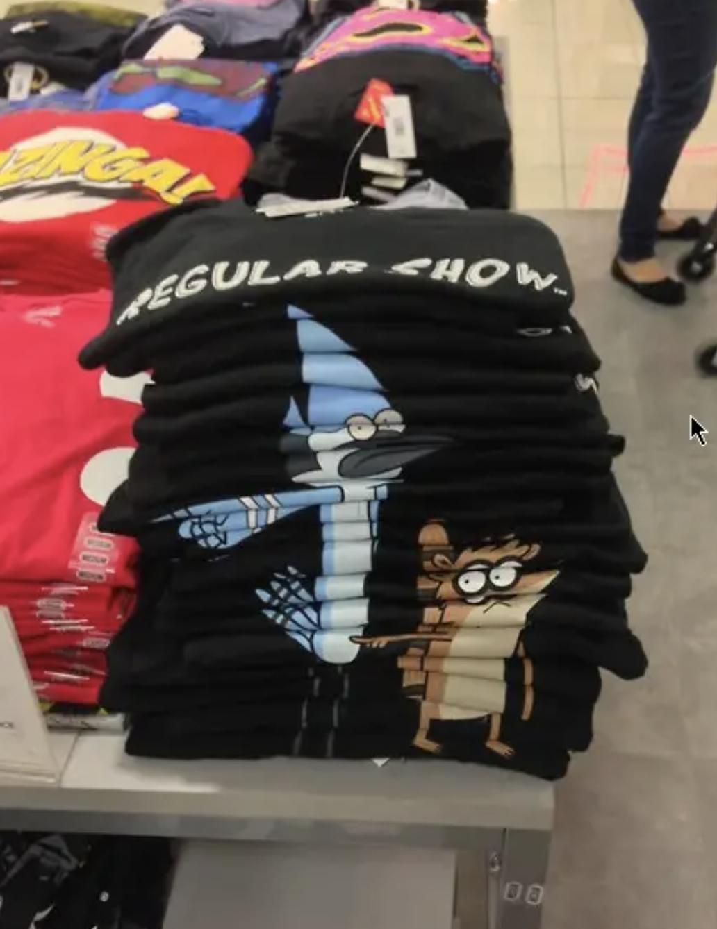 Stack of &#x27;Regular Show&#x27; t-shirts featuring characters Mordecai and Rigby
