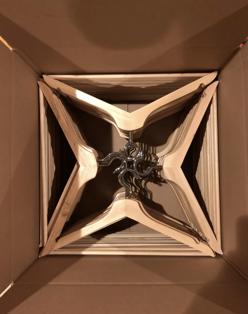 Perspective view inside a cardboard box with a metallic twist tie at the bottom center