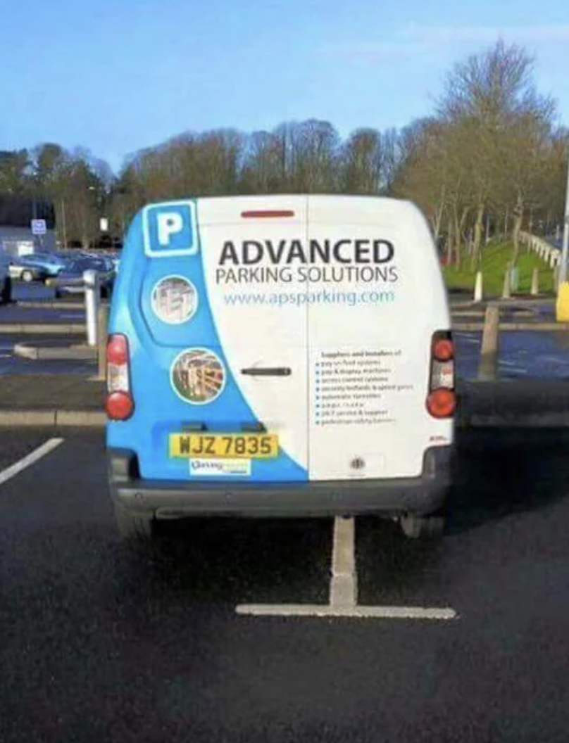 Van with &quot;Advanced Parking Solutions&quot; logo parks occupying two spaces