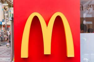 マクドナルドの特徴的な黄色い「M」ロゴが赤い背景に表示されています。