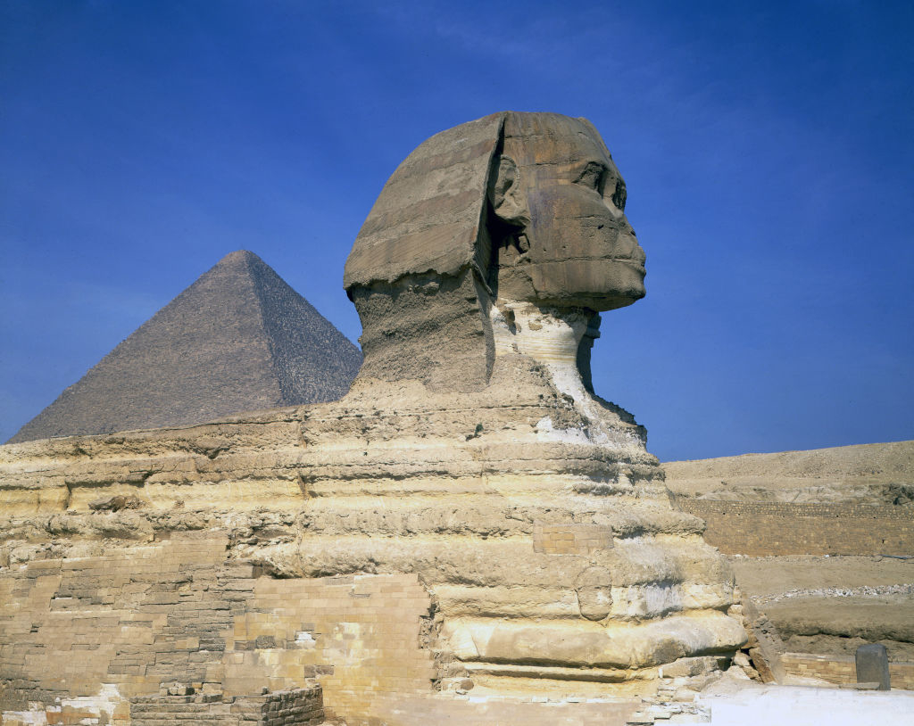 The Great Sphinx of Giza with a pyramid in the background