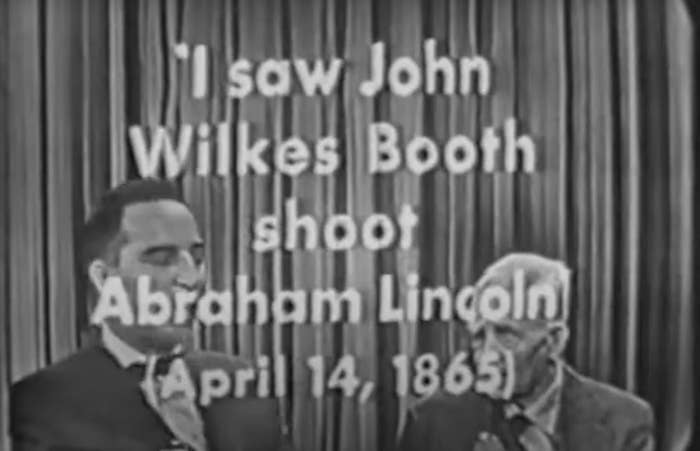 Two men on a vintage TV show; one appears to be recounting his eyewitness account of Abraham Lincoln&#x27;s shooting