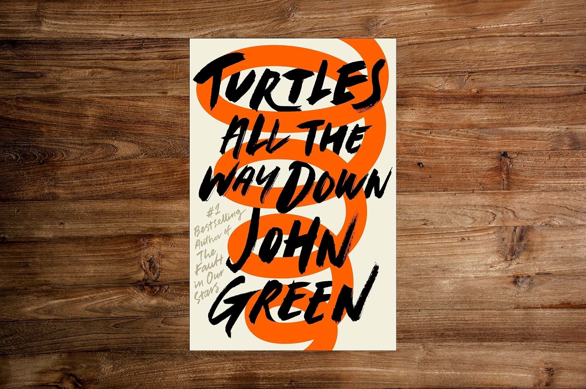Book cover of &quot;Turtles All The Way Down&quot; by John Green with large, intertwined orange text on a white background