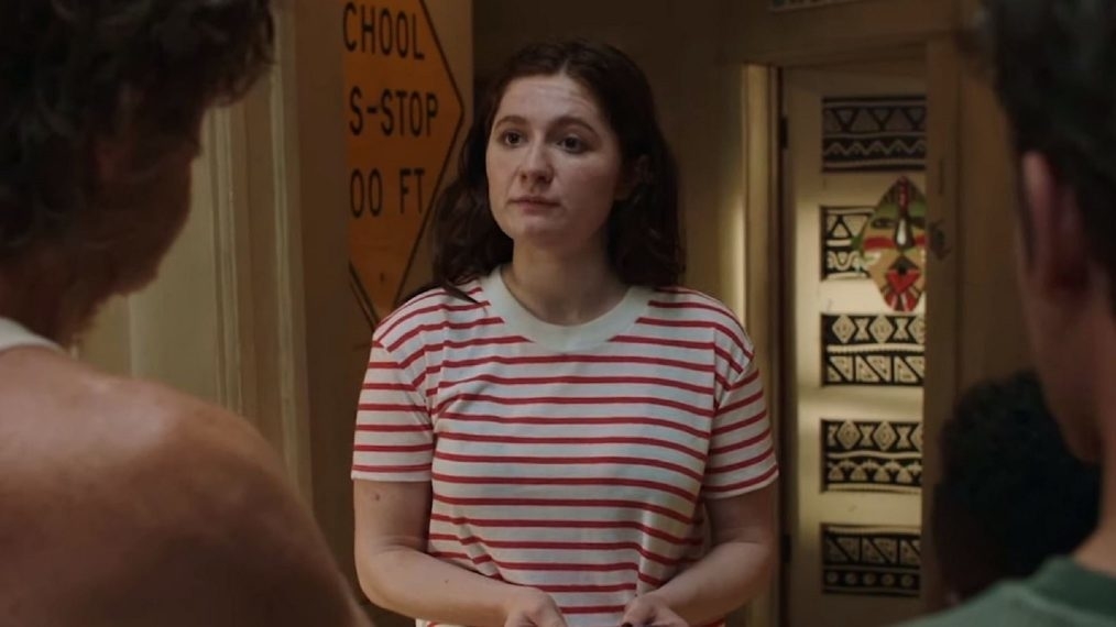 Woman in a striped tee in a scene from a movie or TV show