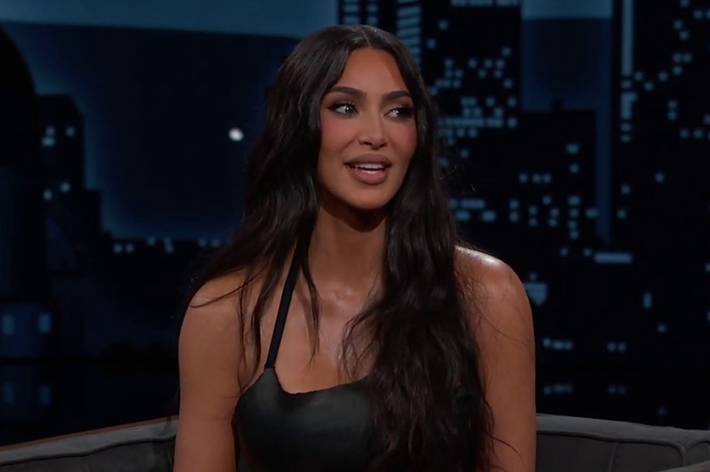 Kim Kardashian in a black top on a talk show set