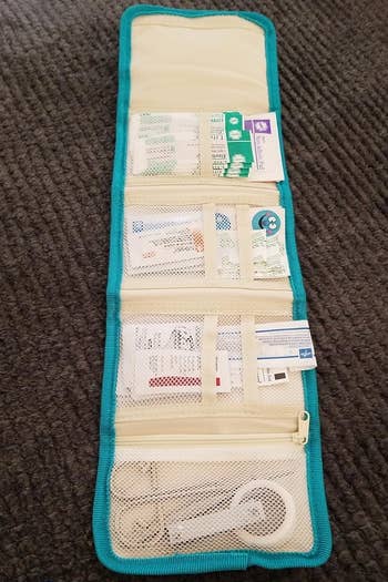 A question organizer laid retired with assorted compartments, immoderate holding cards and travel-sized items