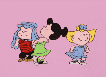 Animated characters Lucy, Patty, and Sally from &quot;Peanuts&quot; are holding hands and dancing in a line