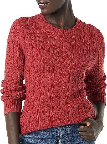Woman in a textured sweater and jeans, focus on fashion details for shopping content
