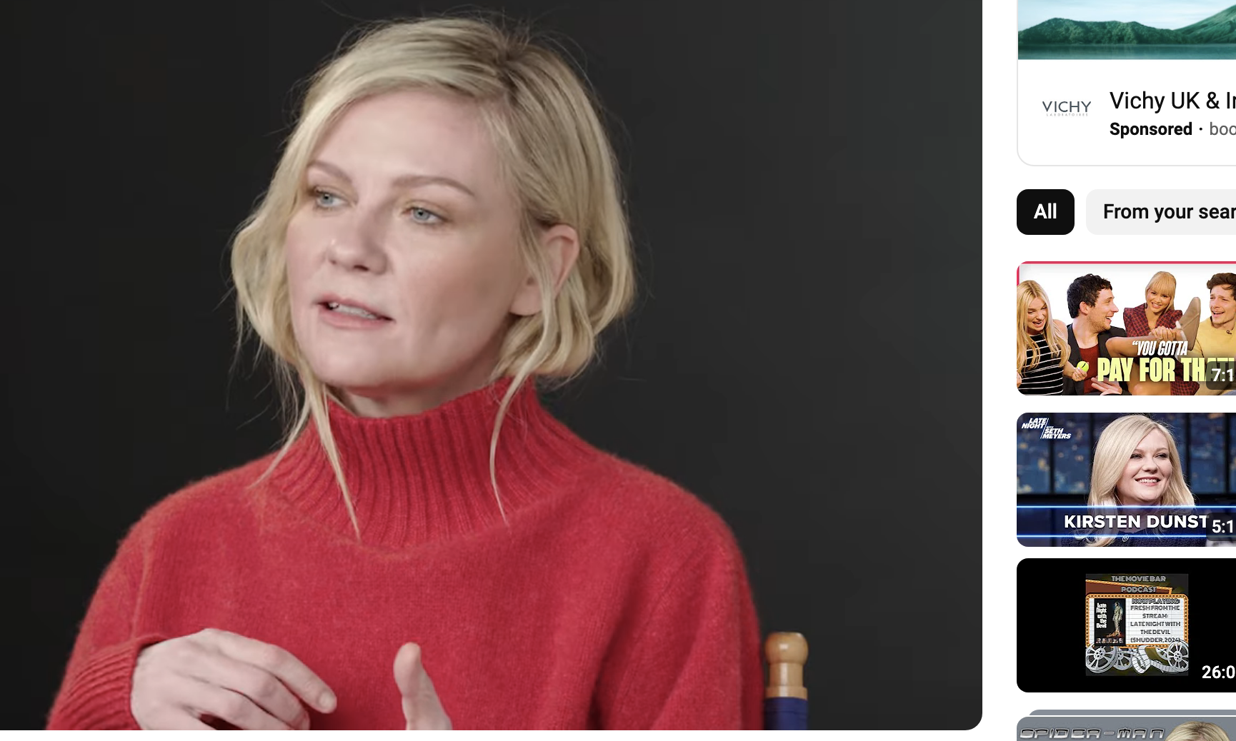 Kristen Dunst in a red turtleneck, discussing a role, in a Youtube video screenshot