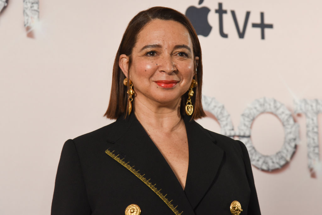 Maya Rudolph posing in a black blazer with gold detailing at an event