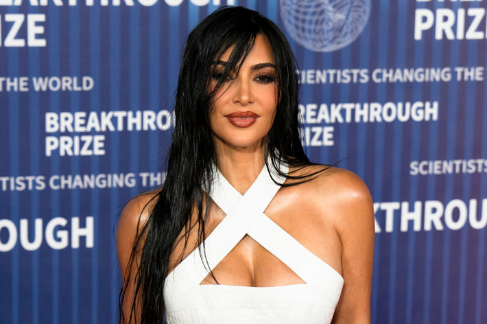 Kim Kardashian in a white crossover neckline dress at the Breakthrough Prize ceremony