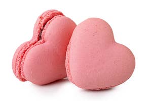 Two heart-shaped macarons isolated on a plain background