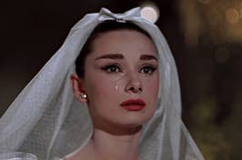 Audrey Hepburn as Jo Stockton looks tearful in a wedding veil from the film "Funny Face."