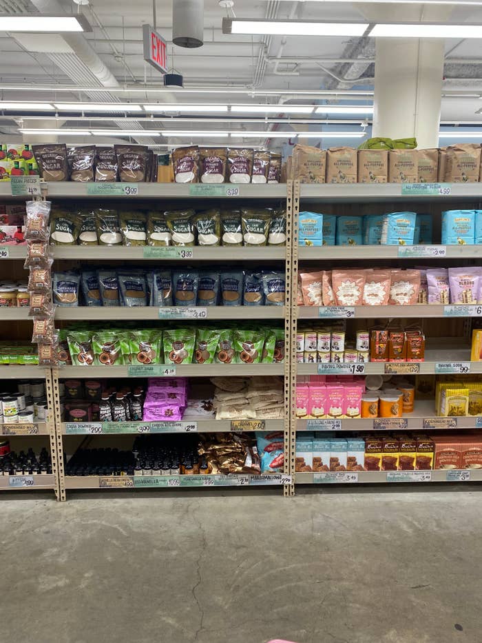 Grocery store shelf stocked with various brands and types of coffee bags