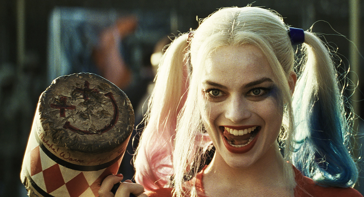 Harley Quinn, from the film, smiling with a bat over her shoulder