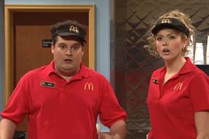 Two actors in McDonald's uniforms on a TV show set, portraying employees, with comedic expressions