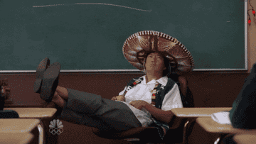 Person wearing a large sombrero and school uniform sitting with feet on desk in a classroom setting. Text reads &quot;I&#x27;ll allow it&quot;