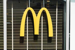 マクドナルドの特徴的な黄色い「M」ロゴが窓に表示されています。