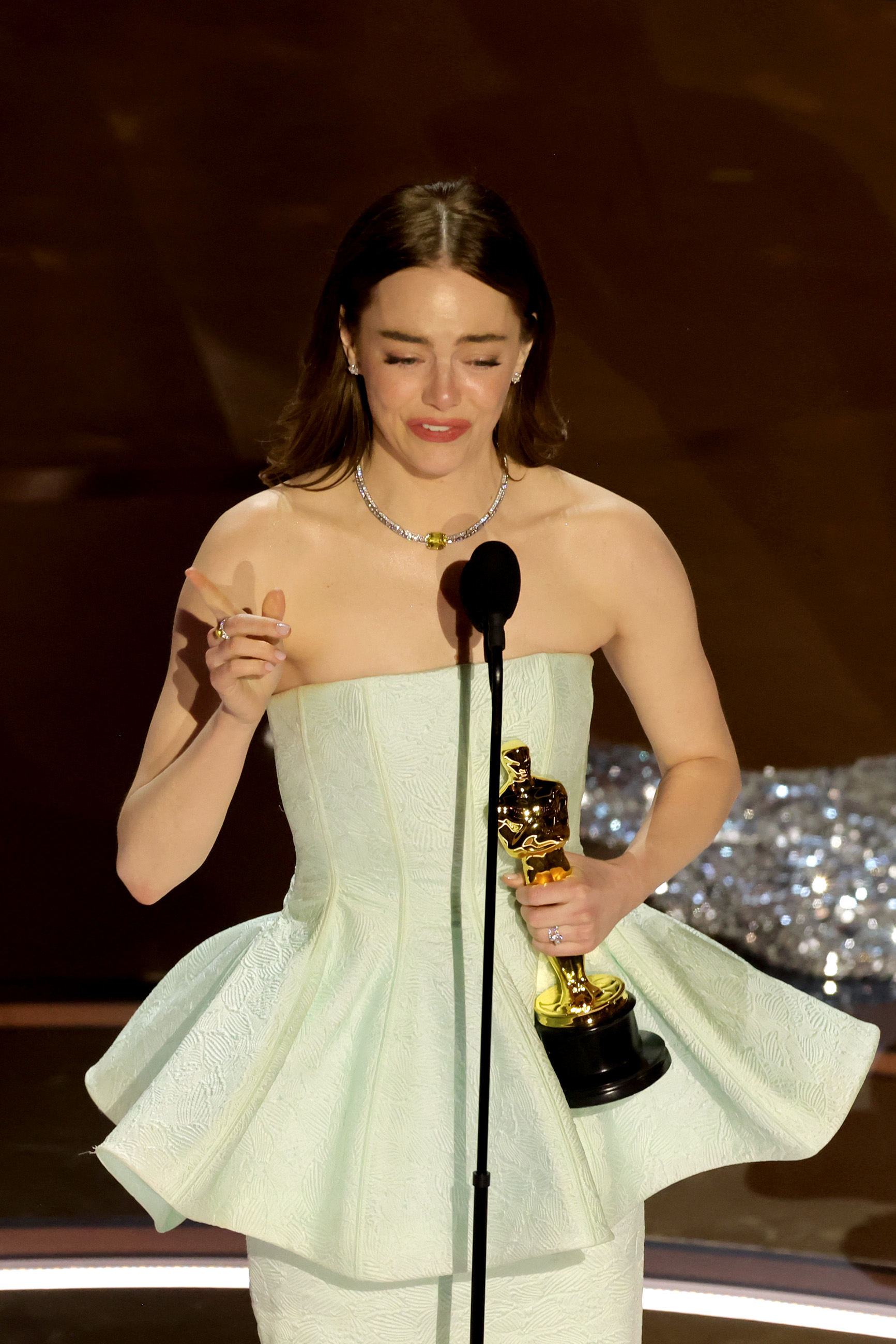 Emma Stone accepting her Oscar onstage