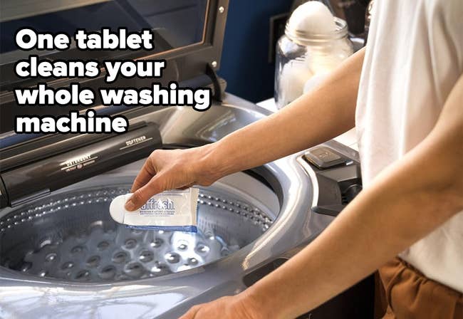 A person adds a cleaning product to a washing machine