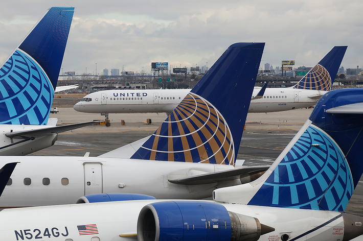 United Airlines aircraft tails with company logo at airport; another plane taxiing in background