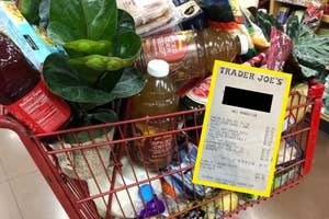 A shopping cart filled with various groceries, including plants and beverages, with an enlarged Trader Joe's receipt overlapping the image