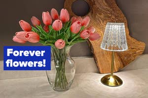 A vase of tulips next to a lamp on a table, with the phrase "Forever flowers!" displayed