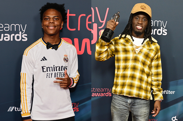 Two individuals on the red carpet at the Streamy Awards, one in a soccer jersey, the other in a plaid shirt and hat holding a trophy