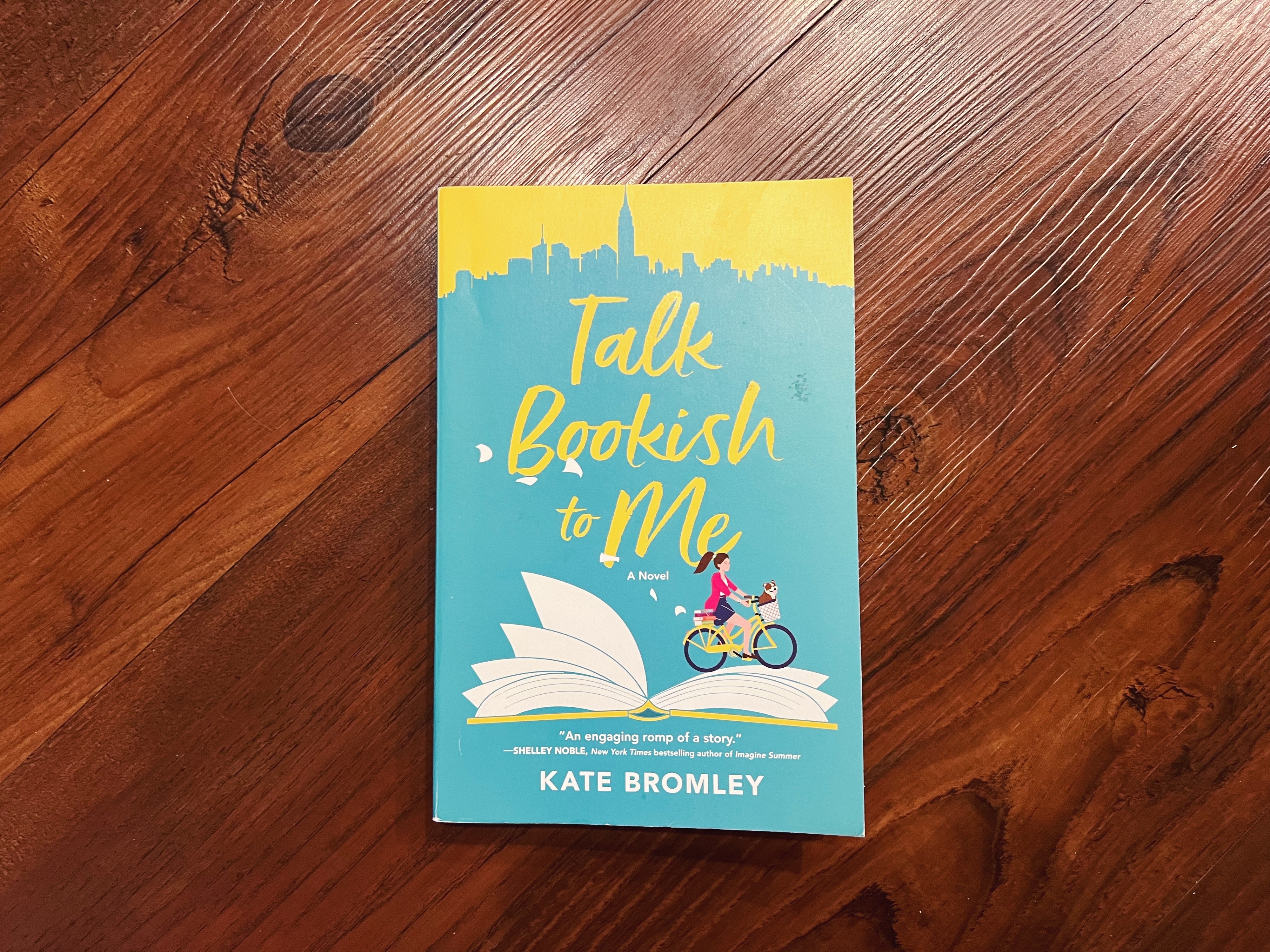 Book &quot;Talk Bookish to Me&quot; by Kate Bromley on a wooden surface