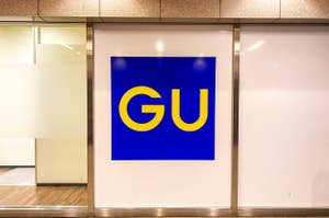 Sign with "GU" logo at a store entrance