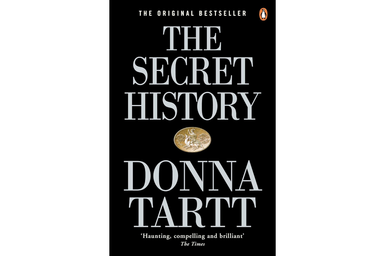 Book cover of &quot;The Secret History&quot; by Donna Tartt with a golden emblem and praise from The Times