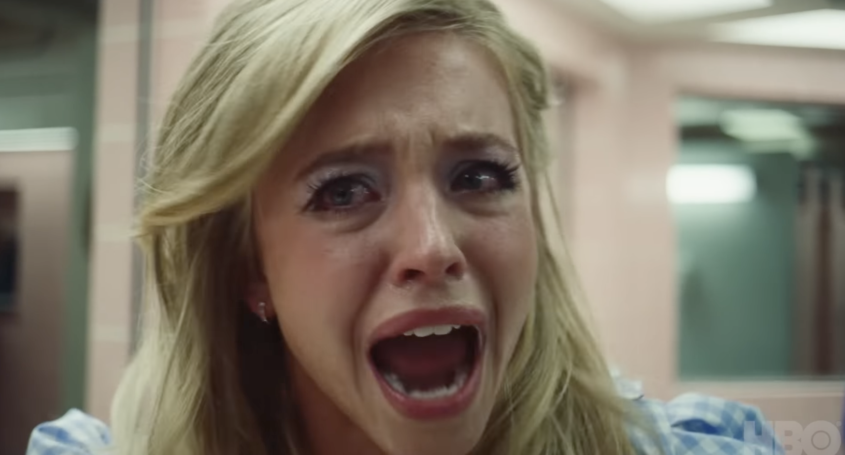 A distressed woman screams, close-up, from a TV show scene. She&#x27;s expressing intense emotion