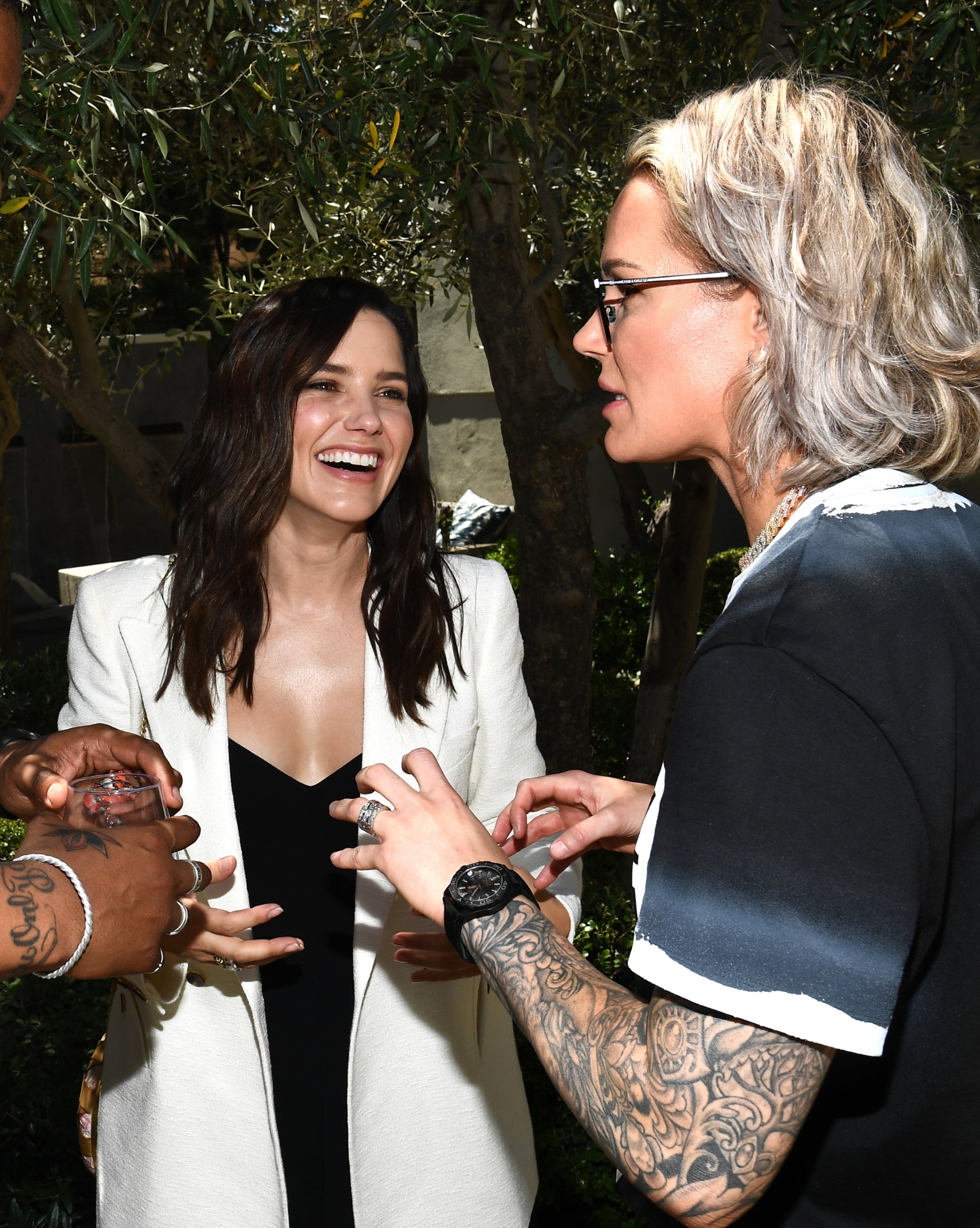 Sophia Bush and Ashlyn Harris talking together with Sophia smiling