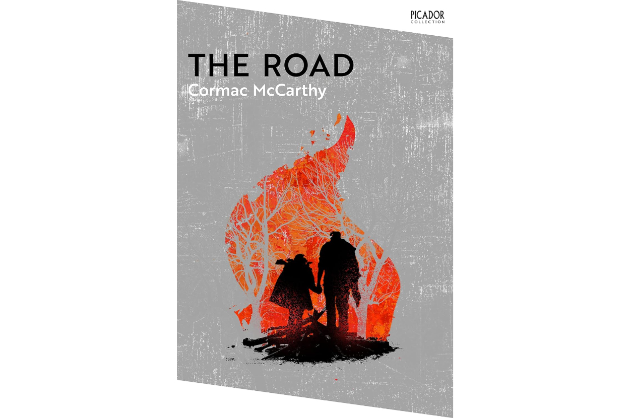 Book cover of &quot;The Road&quot; by Cormac McCarthy, featuring silhouettes of two figures within a fiery shape