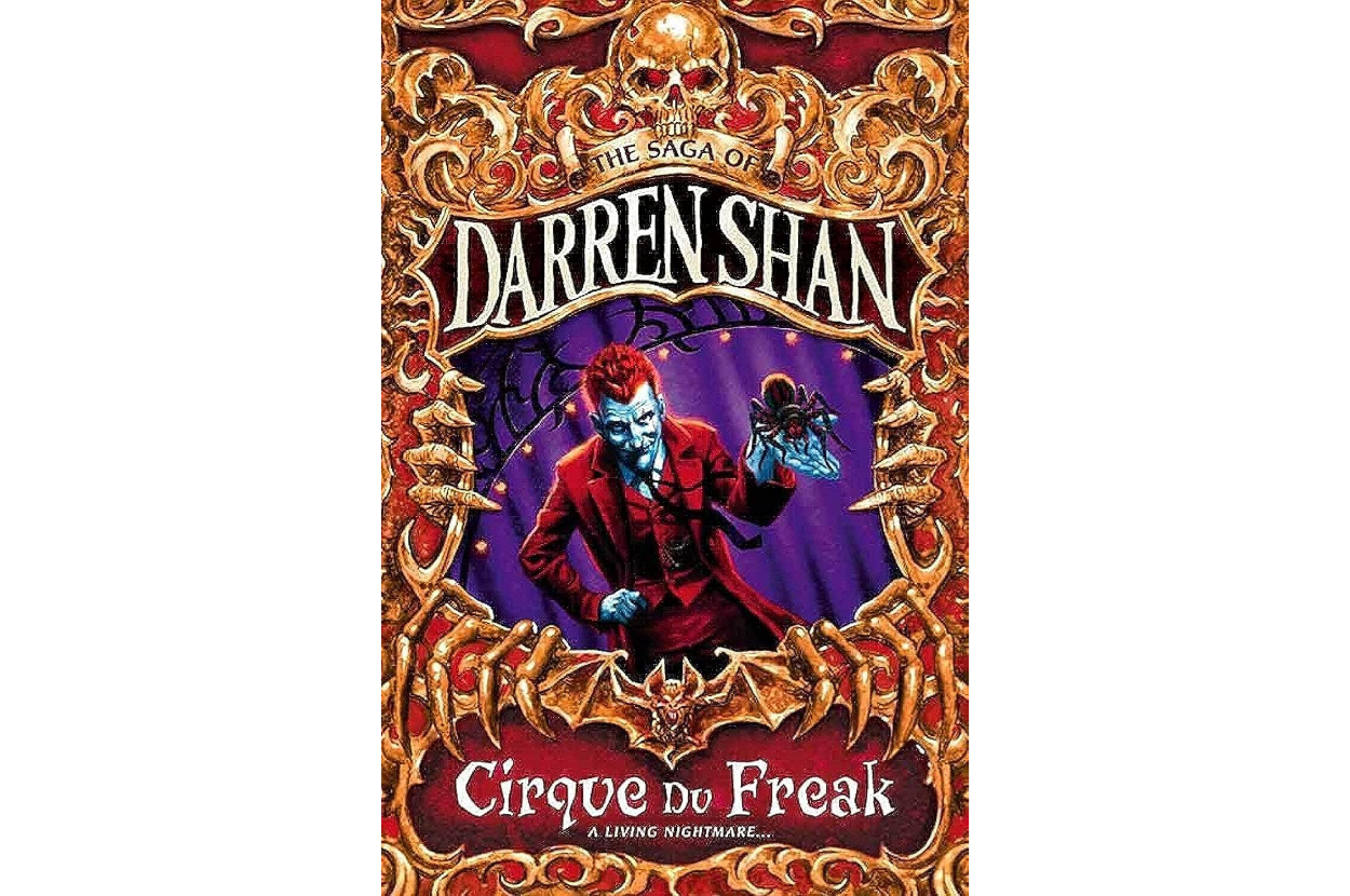 Cover of &quot;Cirque Du Freak&quot; by Darren Shan featuring a vampire holding a spider within ornate borders