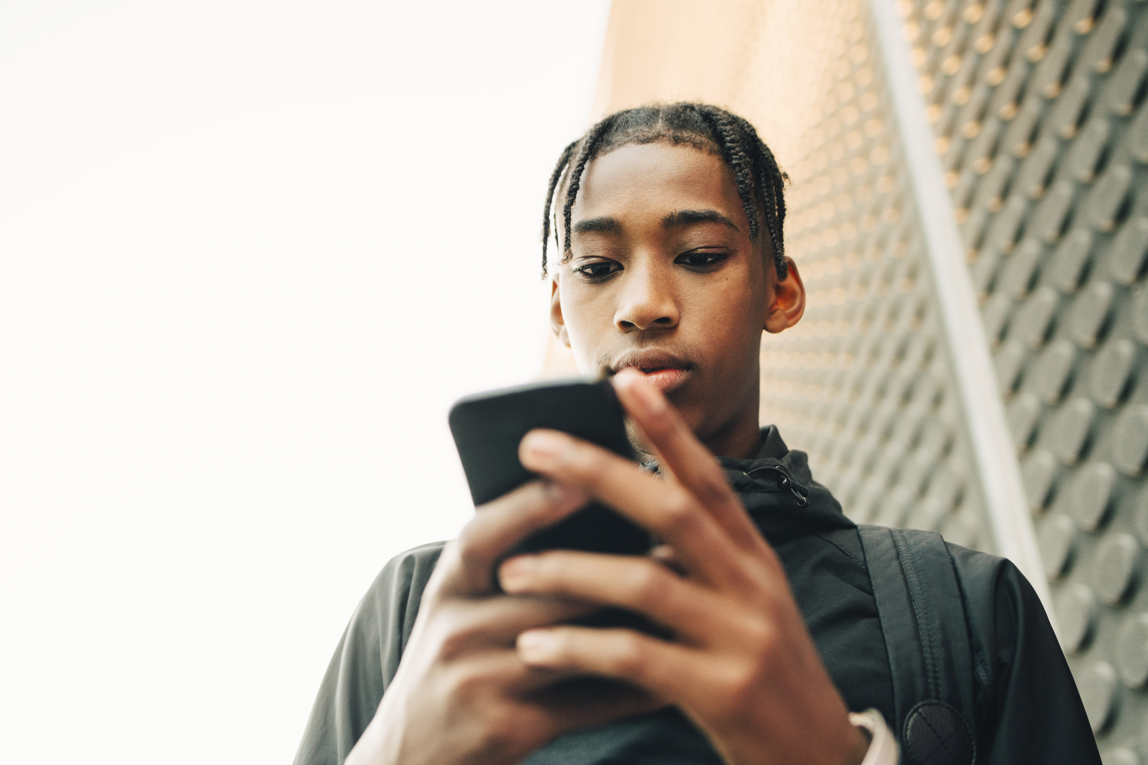 teen boy looking at a phone