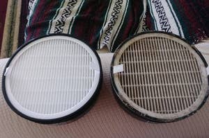 Two air purifier filters side by side, one new and clean, the other old and dirty