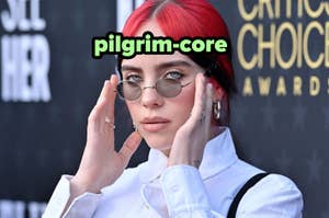 Billie Eilish at event in white shirt and sunglasses, touching her red-dyed hair. Text "pilgrim-core" overlay