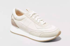 A single white sneaker with a minimalist design displayed against a light background